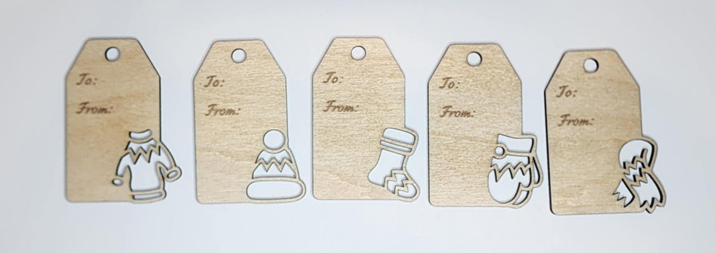 Handmade wooden Christmas gift tags with engraved holiday designs, rustic style.